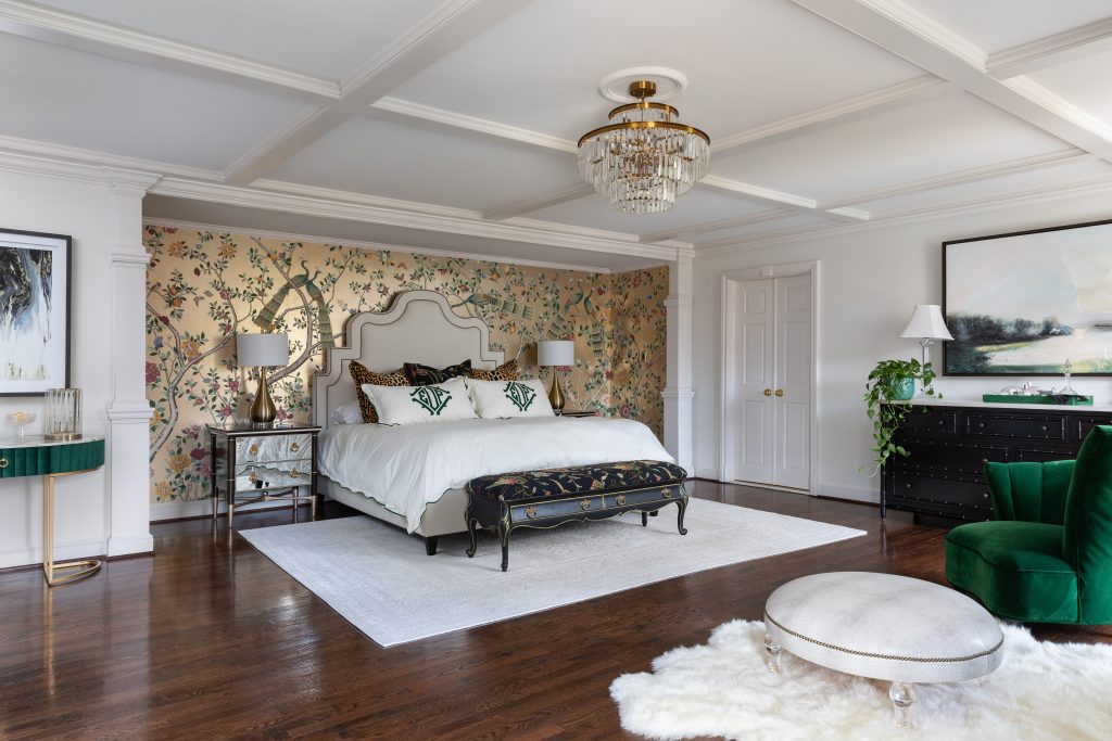 Northern Virginia primary bedroom with chinoiserie wallpaper accent wall, coffered ceiling, crystal chandelier, and emerald green velvet accents by Blue Leopard Interiors